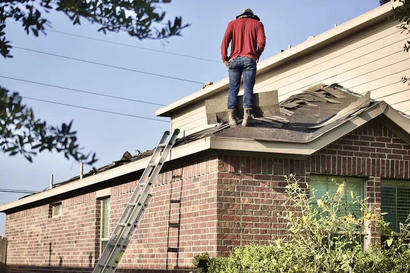 Professional roofer working on a residential roof in Saint Augustine